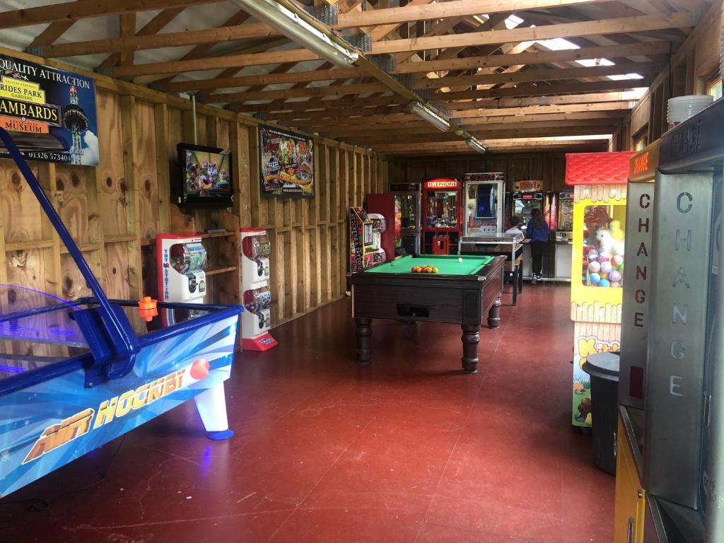 a room with a pool table and a game room at Polladras Holiday Park in Helston