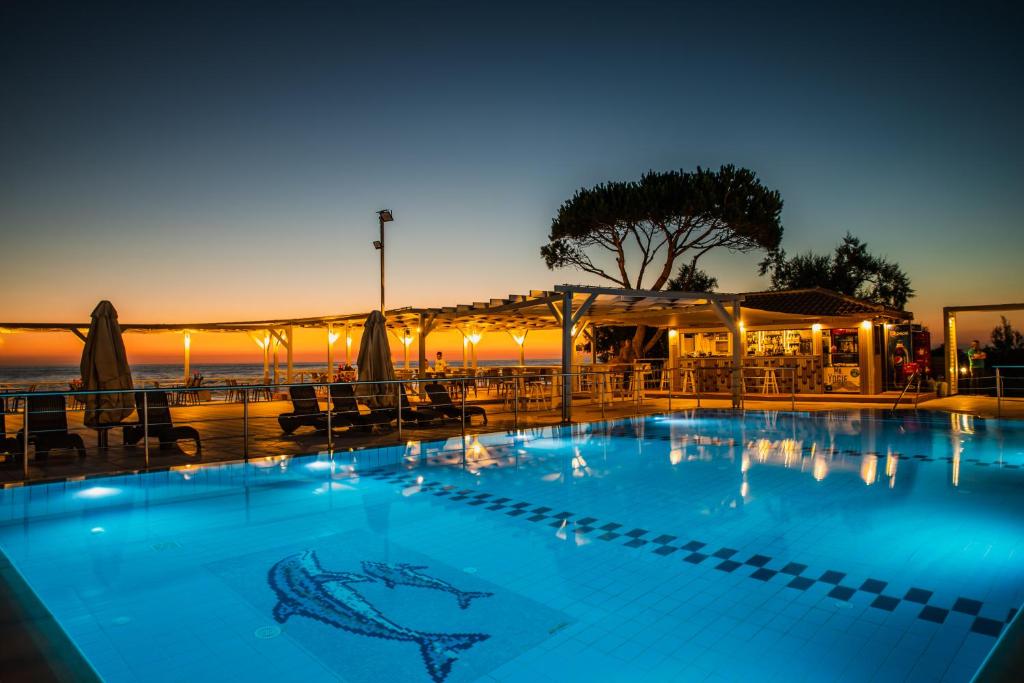 a swimming pool at a resort with a shark painted on it at Mesogeios Hotel in Marathopoli