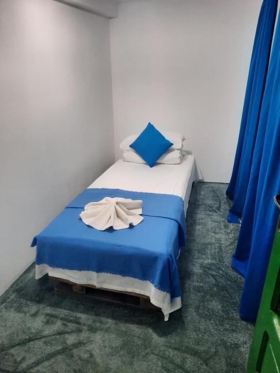 a bedroom with a bed with a white dress on it at Cabana in poiana padurii in Recaş