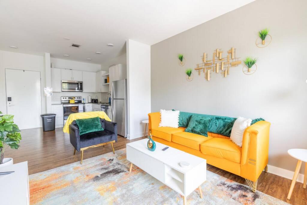 a living room with a yellow couch and a table at Modern Upscale 1BR Fountain Square in Indianapolis