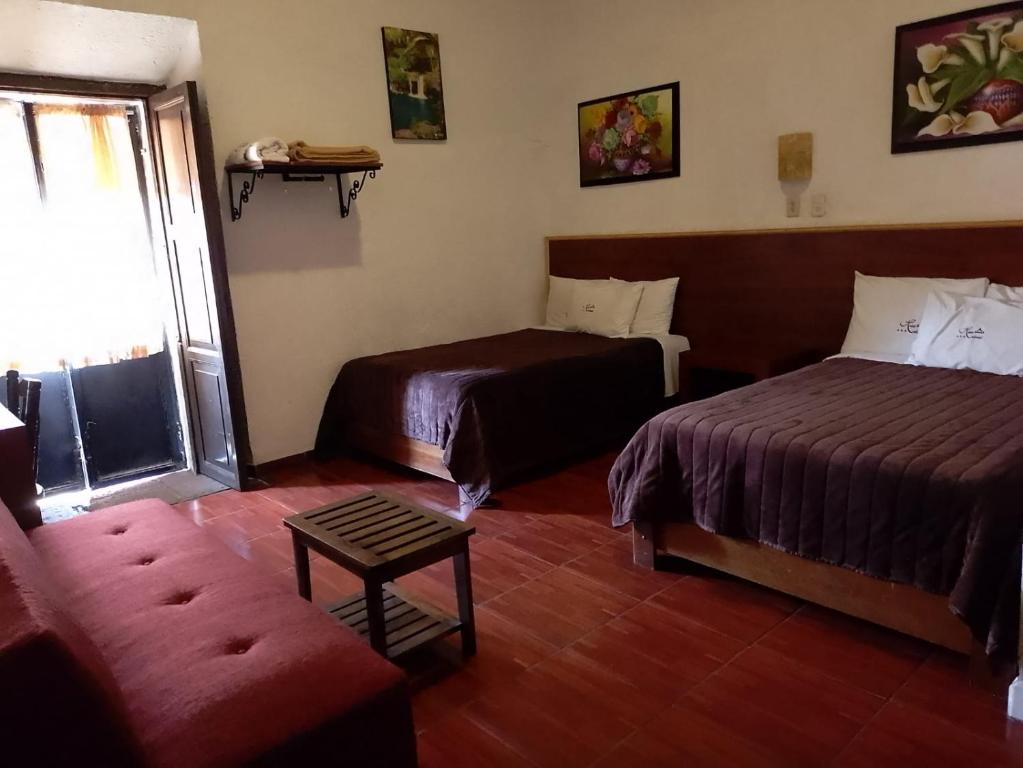 Postel nebo postele na pokoji v ubytování Hotel Colonial