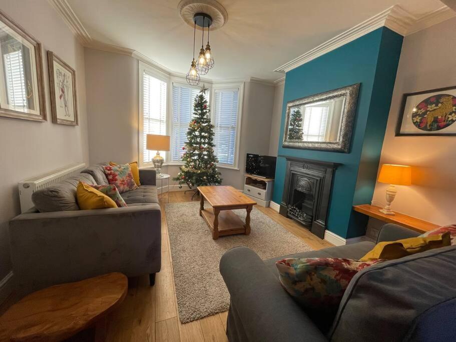 a living room with a christmas tree in it at Gloucester Rd 2 mins away - Fab, new, trendy house in Bristol