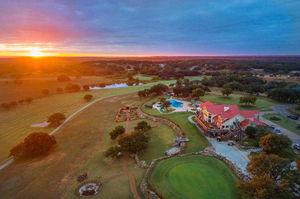 an aerial view of a house with a golf course at The Hideout Golf Club & Resort in Lake Brownwood