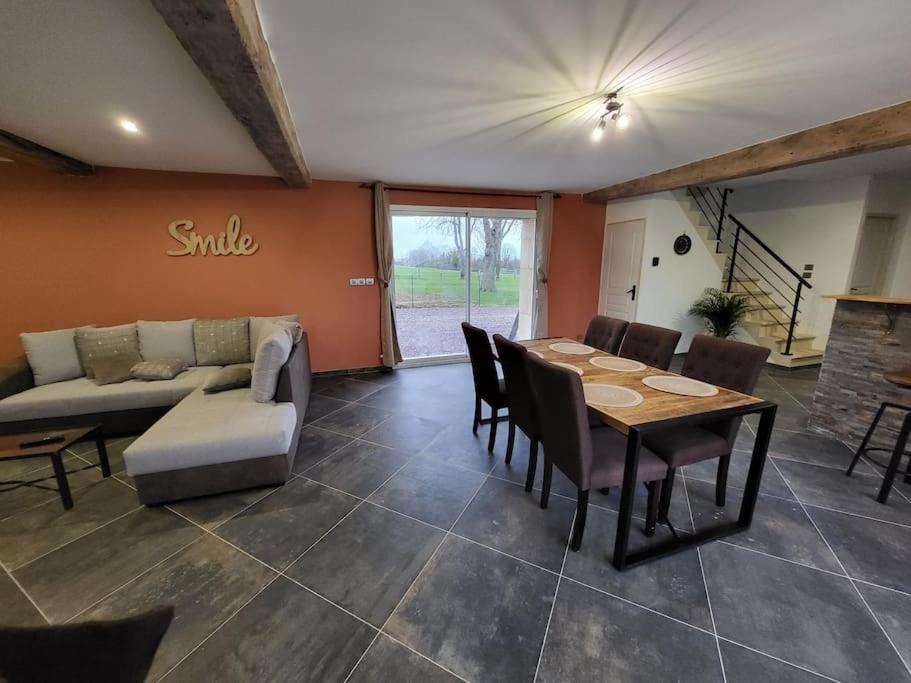 a living room with a table and a couch at gite de l'écurie in Saint-Samson