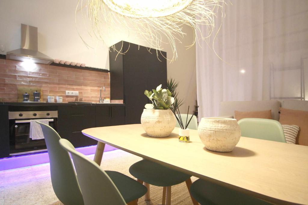 a kitchen with a table with two vases on it at Loft de lujo a estrenar Apartamento n2 in Valencia