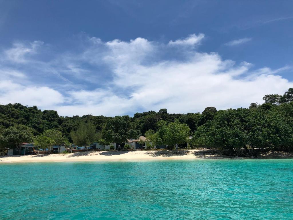 a view of a beach with trees and blue water at Paradise Resort Phi Phi-SHA Plus in Phi Phi Islands