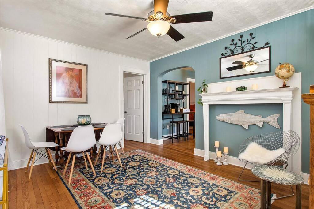 a dining room with a table and a fireplace at Private House Mins to Maymont Park, Trails & VCU! in Richmond