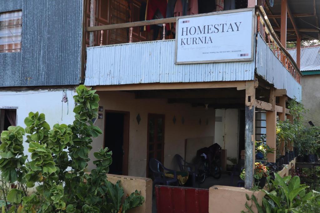 a building with a sign for a homesteadery nirvana at Homestay Kurnia 
