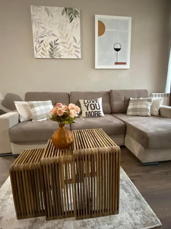 a living room with a couch and a table at m2 Tbilisi Central Park Apartment in Tbilisi City