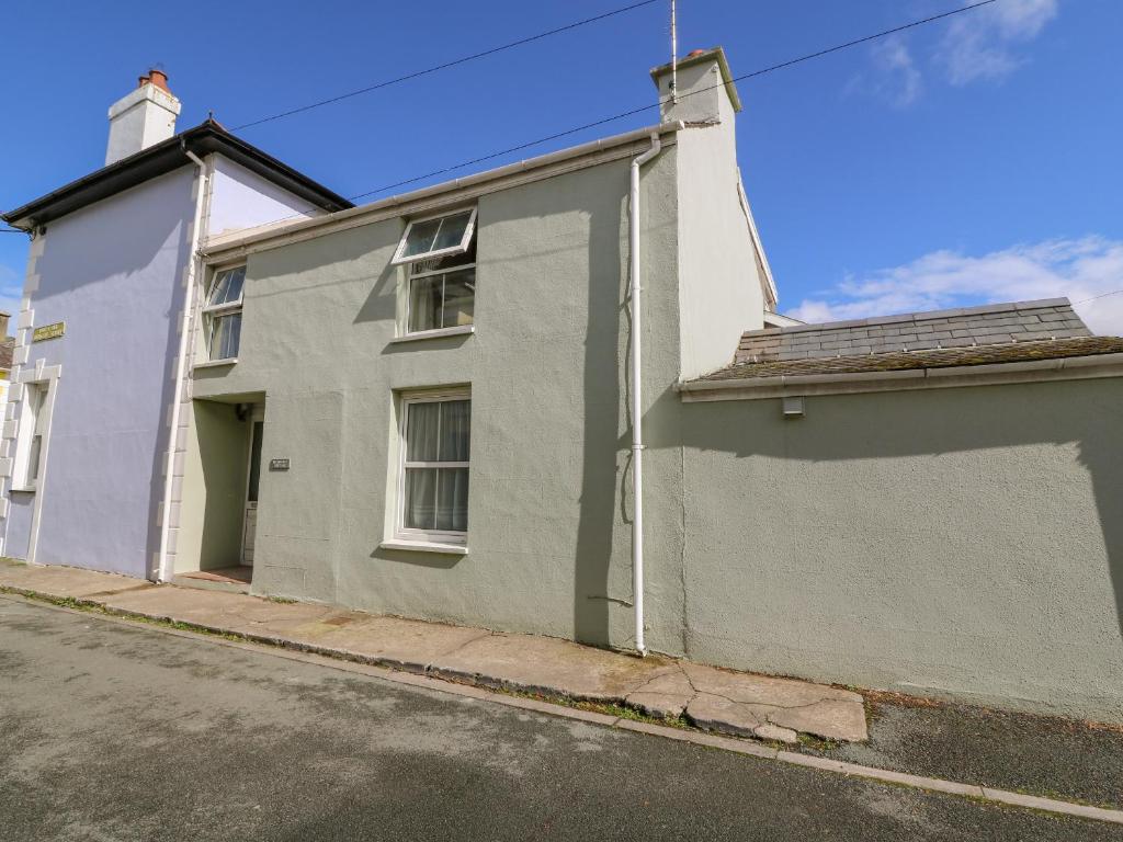 a white house on a street with a road at Melbourne House in Aberaeron