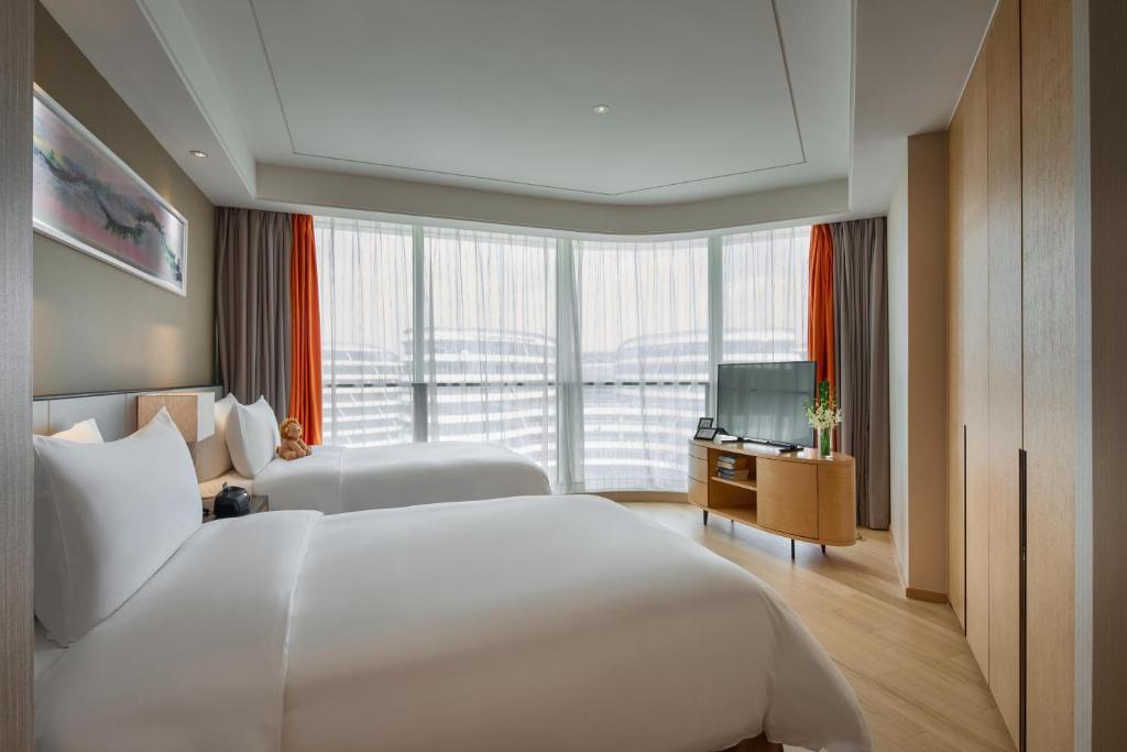 Postel nebo postele na pokoji v ubytování Primus Residence Shanghai Hongqiao