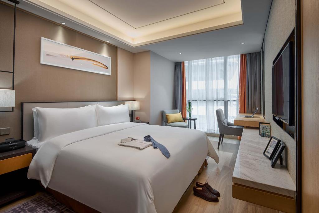 Postel nebo postele na pokoji v ubytování Primus Residence Shanghai Hongqiao