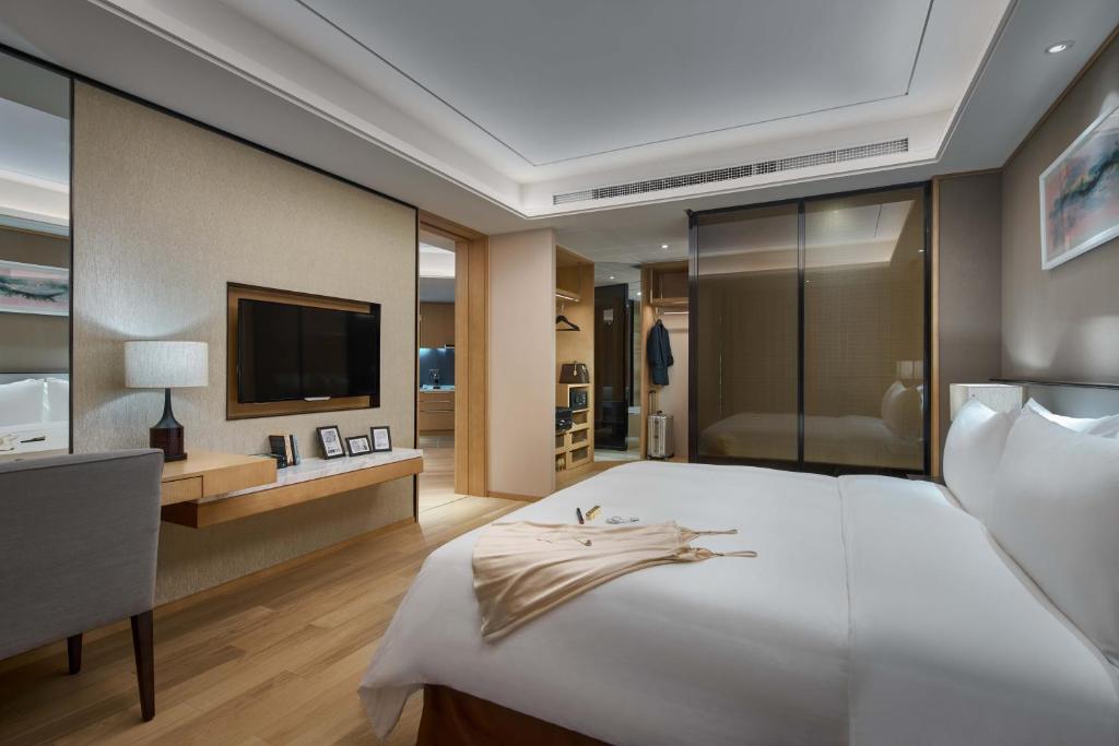 Postel nebo postele na pokoji v ubytování Primus Residence Shanghai Hongqiao