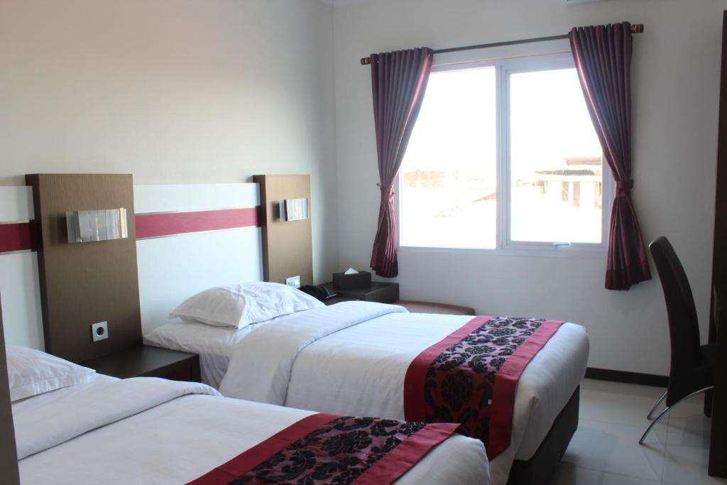 Postel nebo postele na pokoji v ubytování IDEA's Hotel Jalan Ibrahim Aji