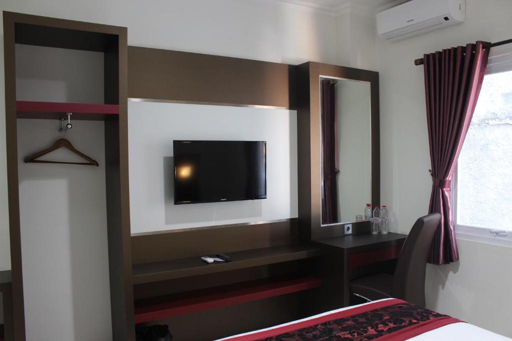 Postel nebo postele na pokoji v ubytování IDEA's Hotel Jalan Ibrahim Aji