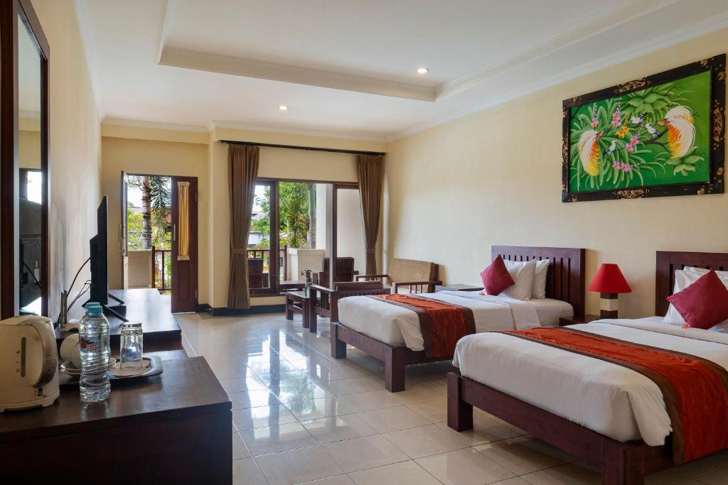 Postel nebo postele na pokoji v ubytování Kusuma Resort Seminyak