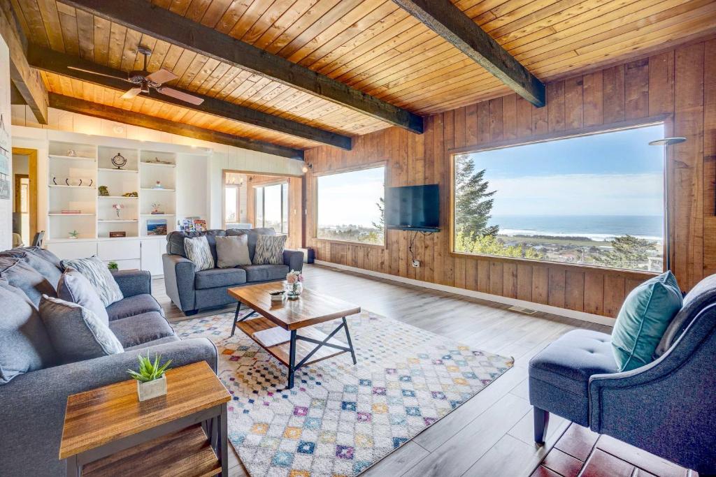 a living room with a couch and a table at Ocean Vista Gold Beach Getaway! in Gold Beach