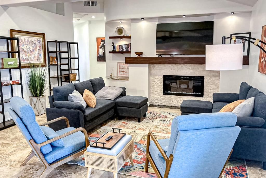 a living room with blue furniture and a fireplace at Piestewa Getaway in Phoenix