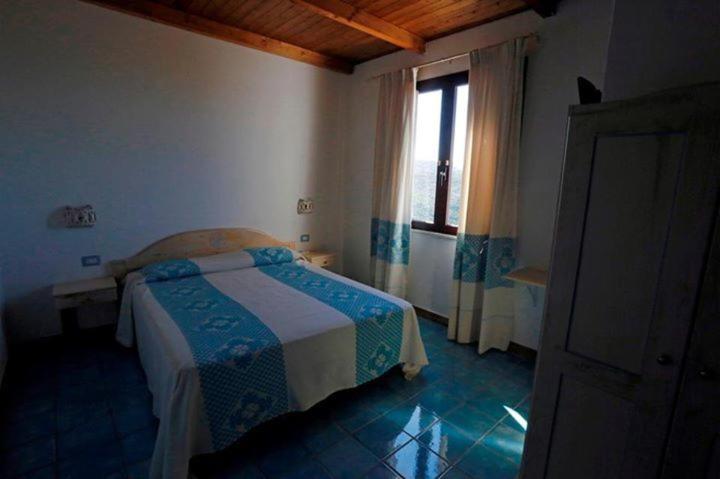 A bed or beds in a room at Agriturismo Irghitula