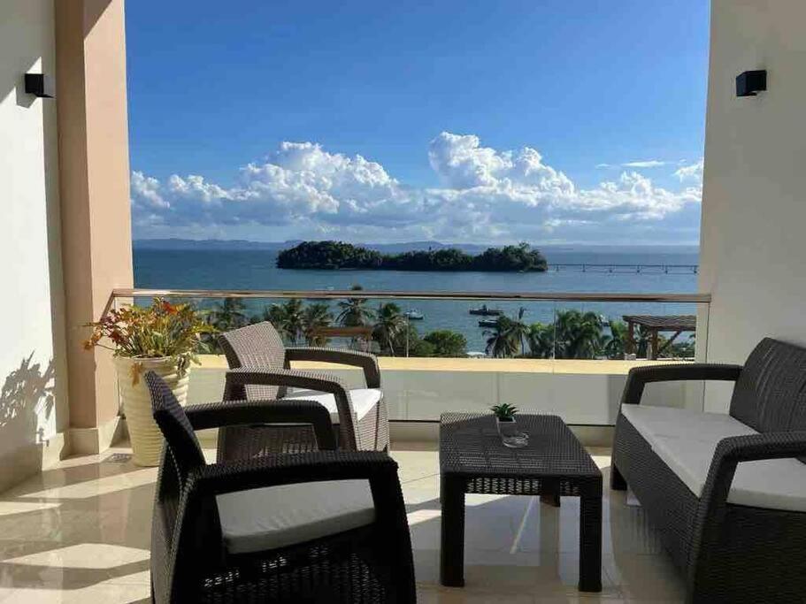 a balcony with chairs and a view of the ocean at Luxury 5 Star Suite At Samana W Marina & Ocean Views in Santa Bárbara de Samaná