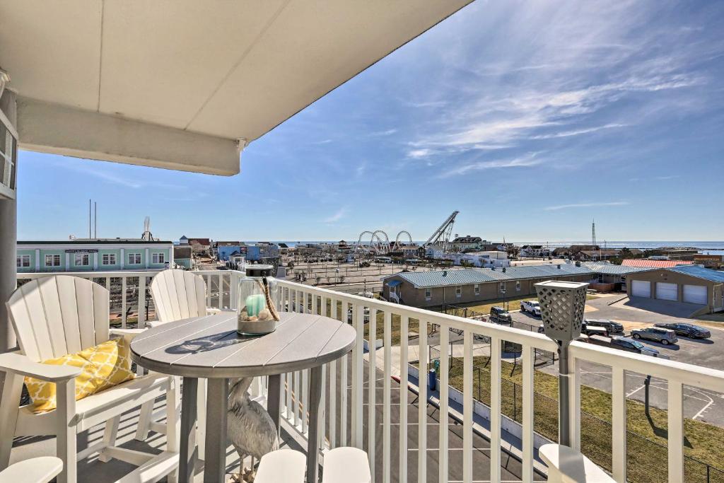 a balcony with a table and chairs and a view of a harbor at End-Unit Ocean City Condo with Panoramic Views! in Ocean City