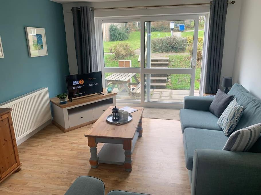 a living room with a couch and a coffee table at An Entire Fabulous Holiday Home - It’s All Yours! in Saint Columb Major