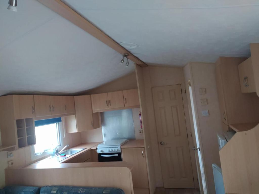 a small kitchen with a sink and a stove at Camping le val du ternois in Frévent