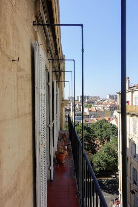 a balcony of a building with a view of a city at Tout le charme de l&#39;ancien marseillais in Marseille