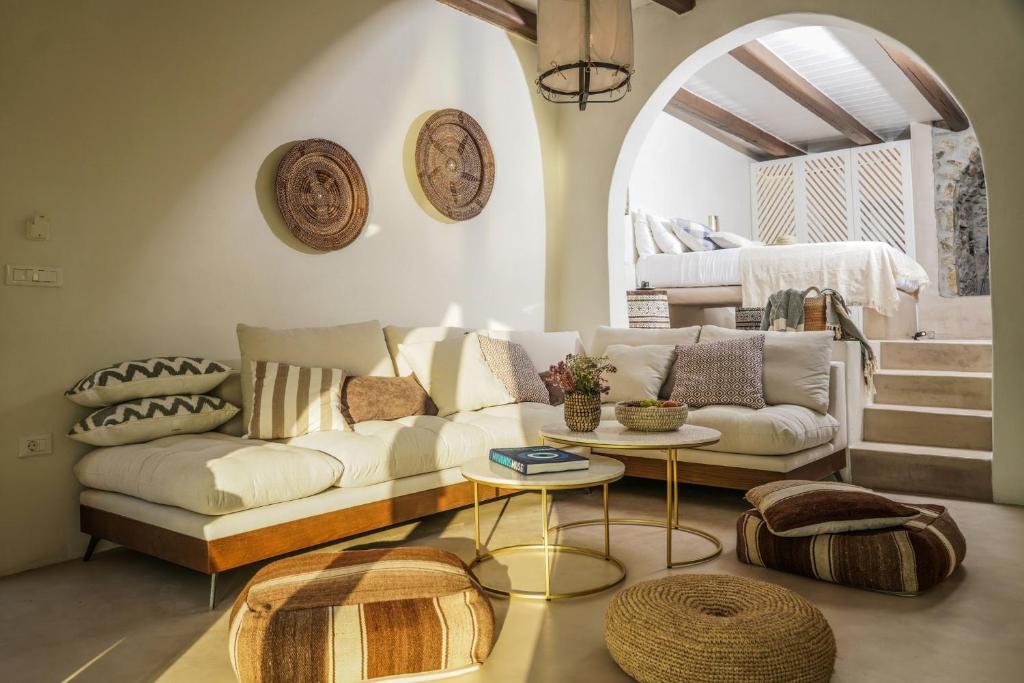 a living room with a couch and a table at Mykonos High Sunset Villa in Mikonos
