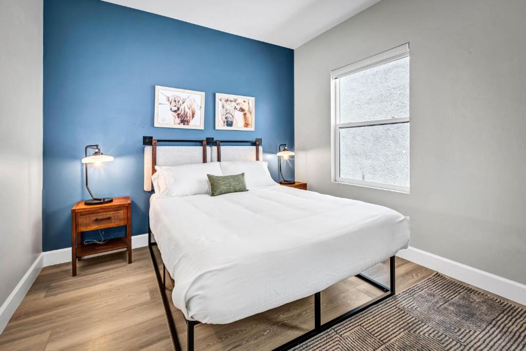 a bedroom with a large white bed and a window at Single Bedroom - Queen Size. Heart of Downtown Vista in Vista