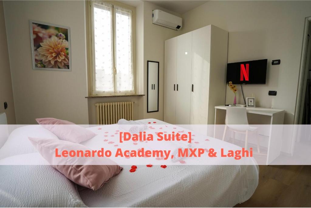 a bedroom with a white bed and a white cabinet at [Dalia Suite] Leonardo Academy, MXP & Lakes in Sesto Calende