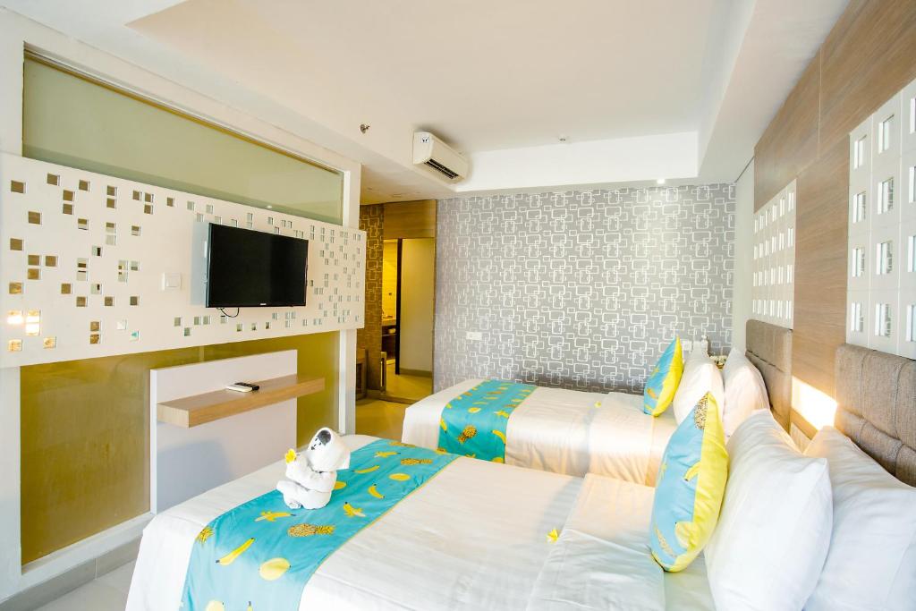 Letto o letti in una camera di Jimbaran Bay Beach Resort and Spa by Prabhu