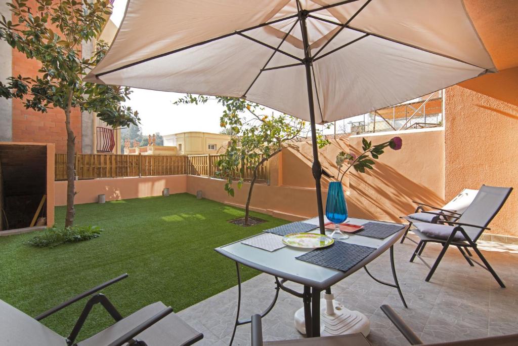 a patio with a table and an umbrella at Holiday home Splendid Park Güell in Barcelona