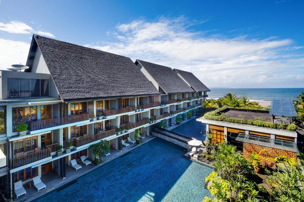 uma vista aérea do resort com o oceano ao fundo em Swarga Suites Bali Berawa em Canggu