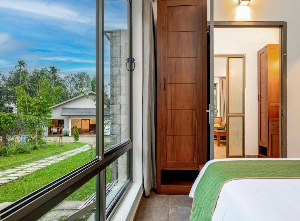 Postel nebo postele na pokoji v ubytování Coffee Greens Resort