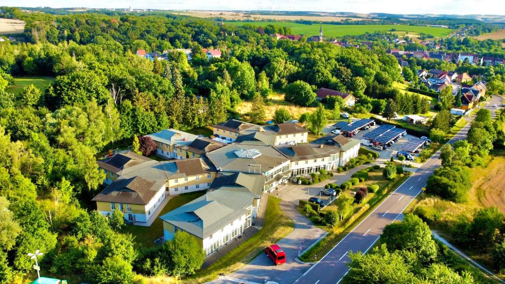 an aerial view of a resort building with a parking lot at Atrium Hotel Amadeus in Osterfeld