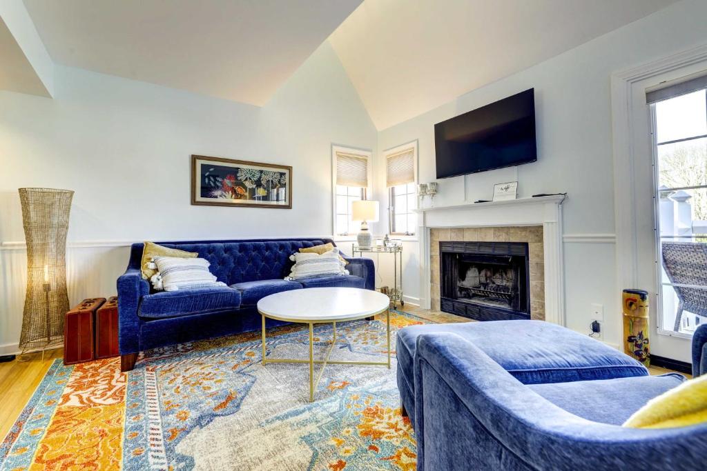 a living room with a blue couch and a fireplace at Lovely Norwich Villa with Shared Amenities! in Norwich