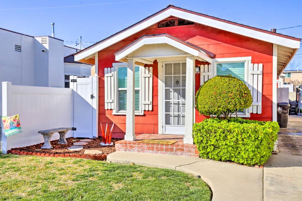 a red house with a bench in front of it at Colorful Long Beach Bungalow with Patio and Grill in Long Beach