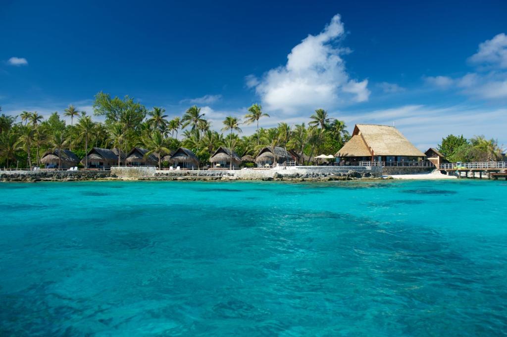 an island in the ocean with overwater bungalows at Maitai Rangiroa in Avatoru