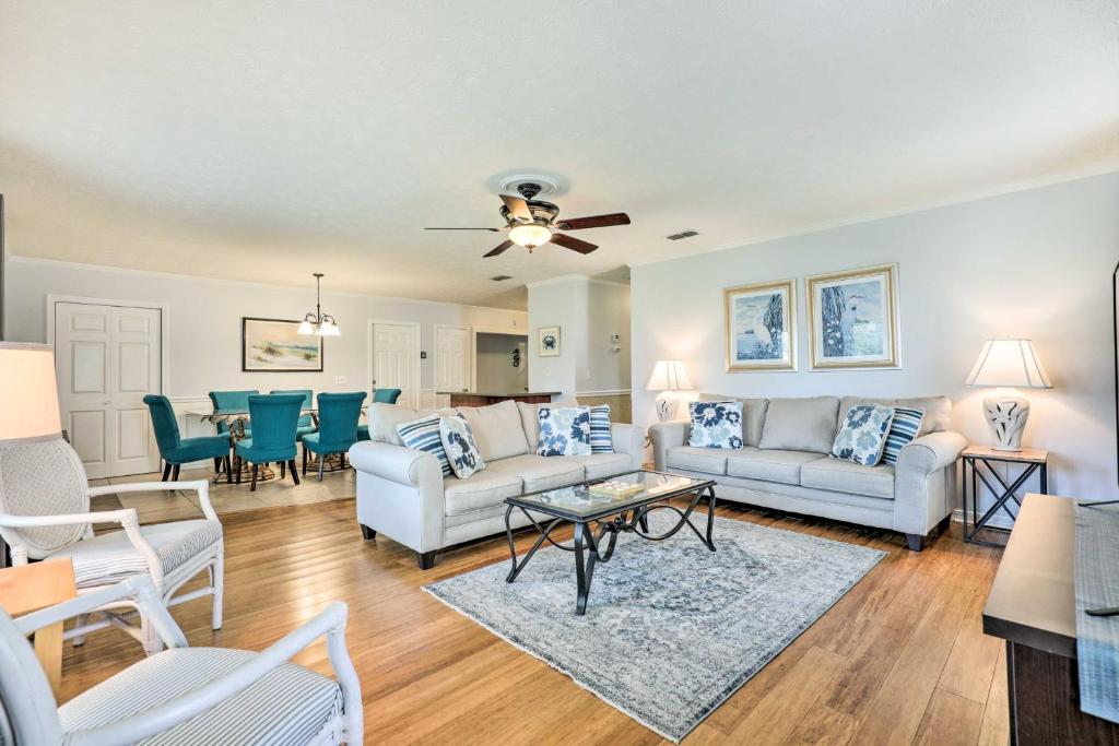 a living room with a couch and a table at St Augustine Island Home with Patio, Walk to Beach! in Saint Augustine