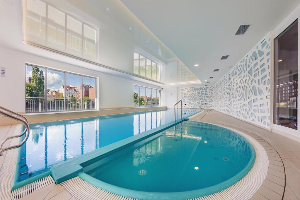 a swimming pool in a house with a large swimming pool at Waterlane Island, Sun & Snow in Gdańsk
