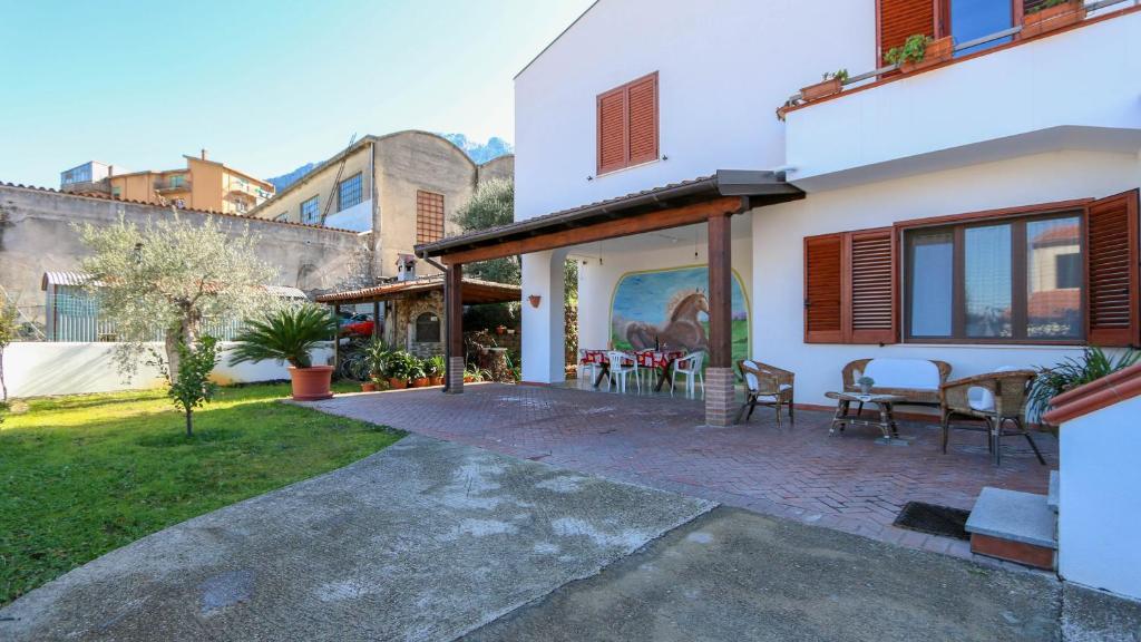 Cette maison dispose d'une terrasse avec une table et des chaises. dans l'établissement Casa Pia, à Oliena