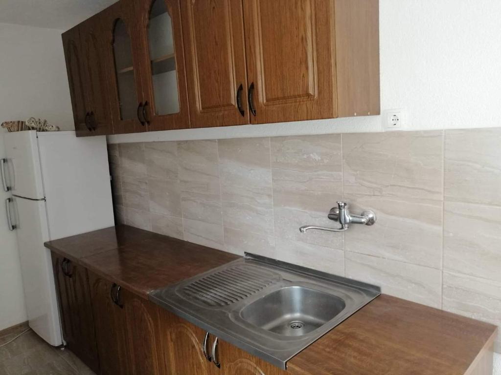 a kitchen counter with a sink and a refrigerator at Holiday home Dream Bosanska Krupa in Bosanska Krupa