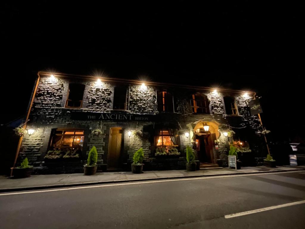 a building with lights on the side of a street at The Ancient Briton in Pen-y-cae