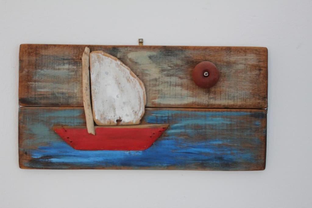 a painting of a boat with a red paddler at Lovely villa in the gorgeous Porto Hydra in Thermisía