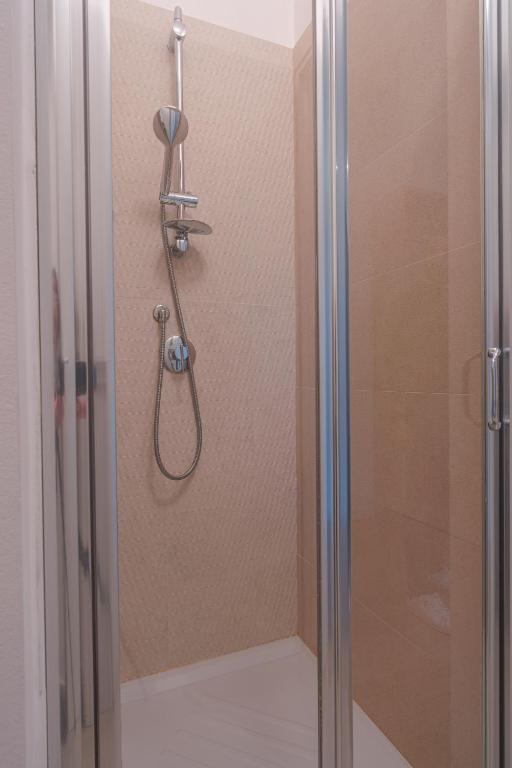a shower in a bathroom with a glass door at Casa Lighea Mondello - 200 mt dalla spiaggia in Mondello