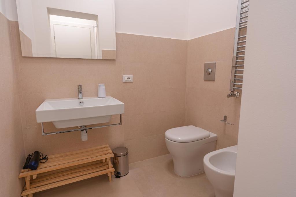 a bathroom with a sink and a toilet and a mirror at Casa Lighea Mondello - 200 mt dalla spiaggia in Mondello