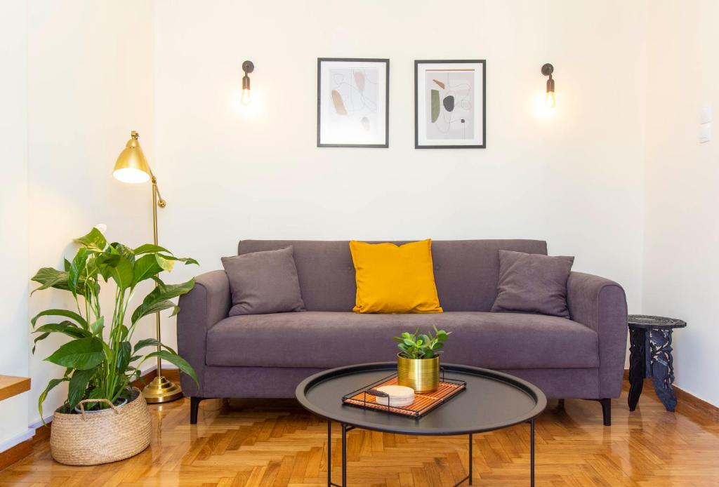 a living room with a purple couch and a table at Lucas apartment 1 in Athens