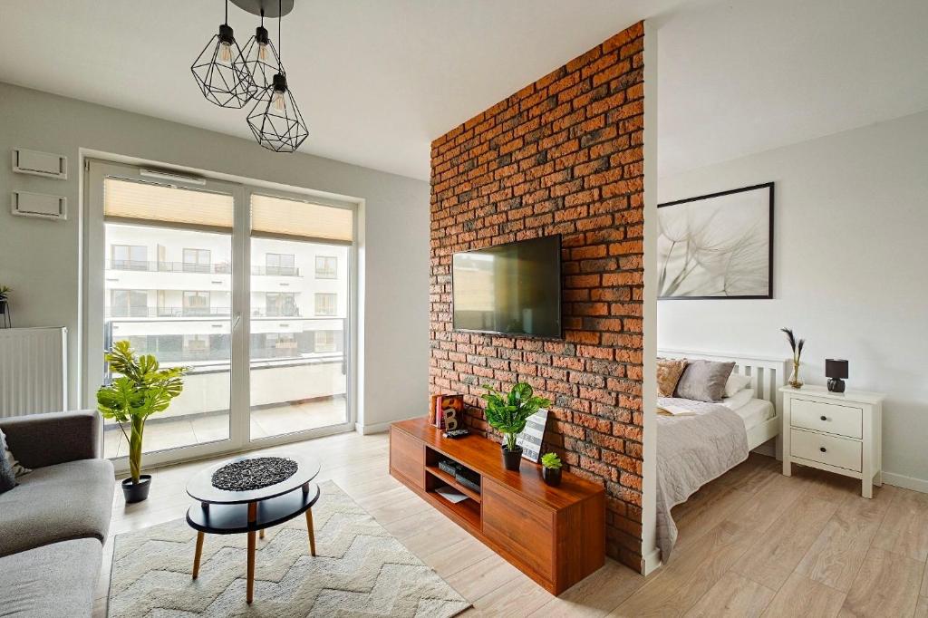 a living room with a brick wall at Warsaw Inside Business Centre in Warsaw