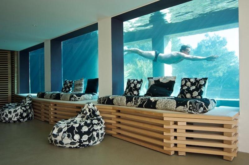 een kamer met twee banken voor een aquarium bij VILLA ON THE ROCKS BANDOL in Bandol